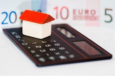 Imagen con una casa, una calculadora y unos billetes de euro